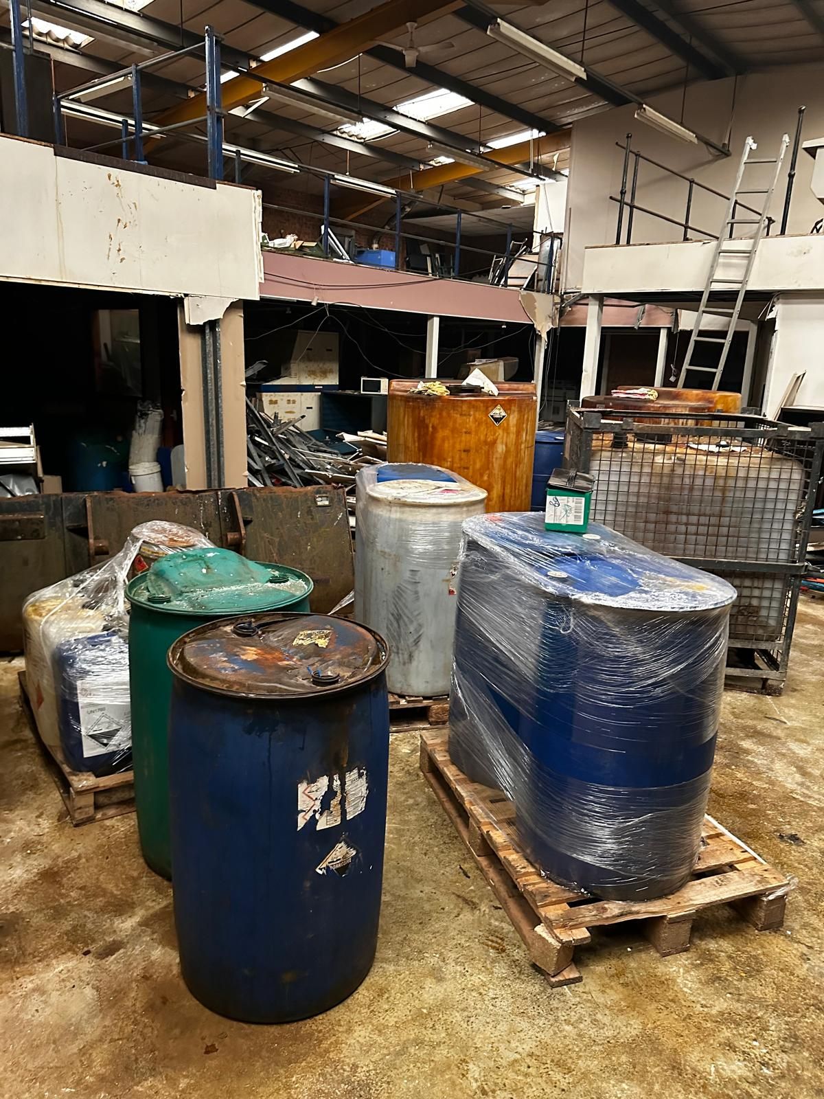 Bulk waste containers lined up in a yard, ready for removal from a site.